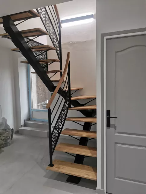 Escalier 2/4 tournant, limon central en acier Marches et main courante en chêne garde corps avec 2 lisses+ habillage décoratif "oriental" Laquage ral noir 9005 FT 72140 ROUESSE-VASSE