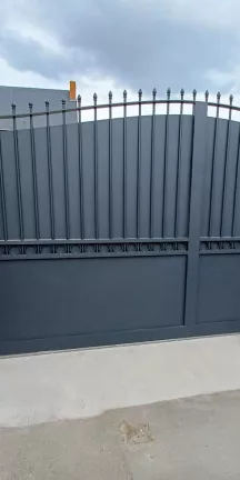 Portail coulissant forme chapeau de gendarme en aluminium Barraudage, festonnage, soubassement en tôles, volutes, fer de lances Laquage ral 7016 FT 53270 CHAMMES